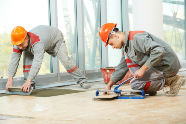 Tile Installers laying down tiles and adhesive