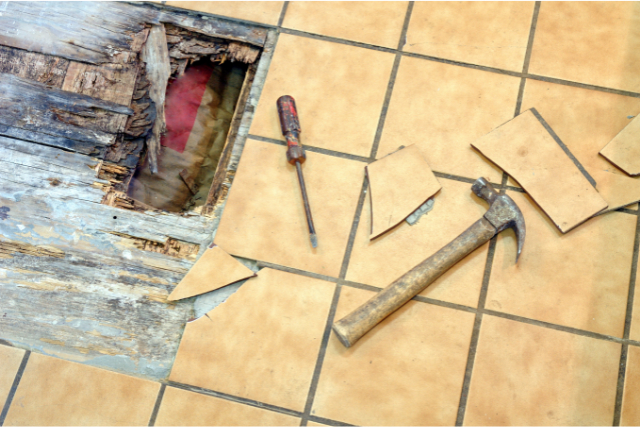 Bend Tile Repair with hammer and screwdriver and broken tiles